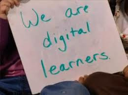 student holding sign saying that he is a 21st century learner