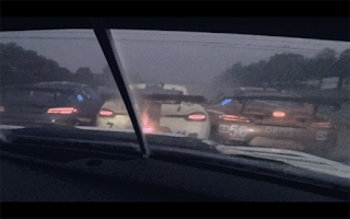 In car screenshot of three cars in front