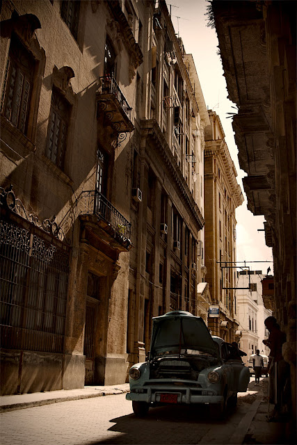 a typical street in Havana with a classic car 