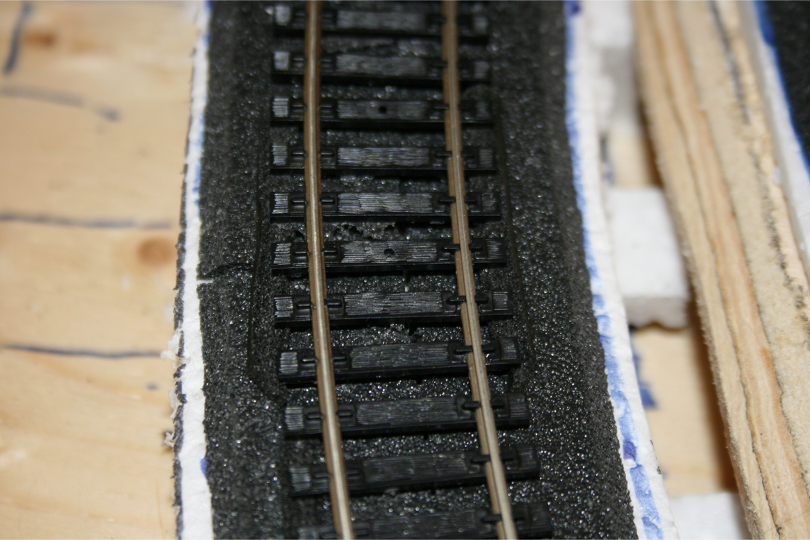 Closeup of track, foam roadbed and foam shims under track ties
