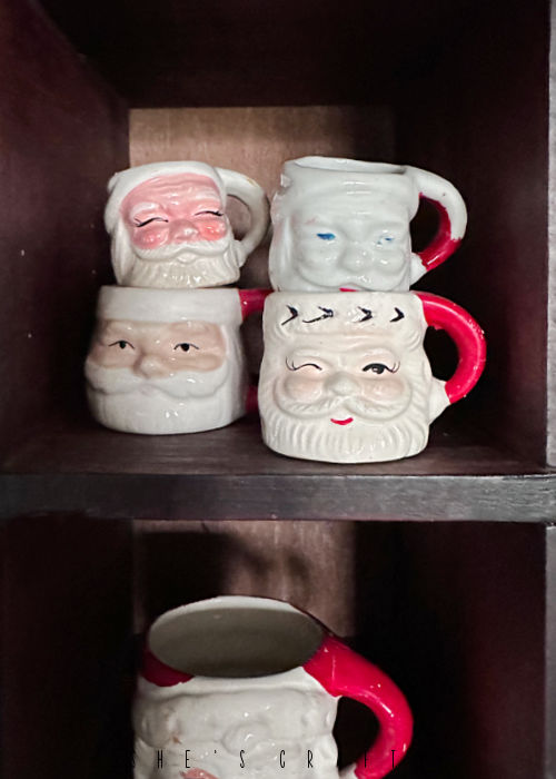Santa mug collection in vintage cubbies.