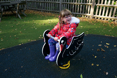 Jessica on a rocking black swan at the playground