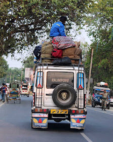 man sitting on the roof of a taxi