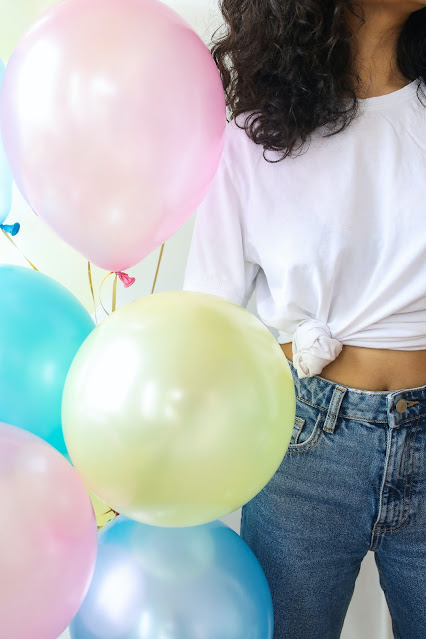 woman holding balloons