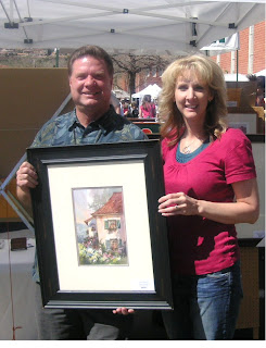 Roland Lee and Jennifer Stucki with painting she purchased at St. George Art Festival