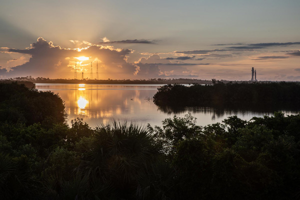 As the Sun rises, the mobile launcher carrying NASA's Space Launch System rocket continues its journey to Pad 39B at Kennedy Space Center in Florida...on June 6, 2022.