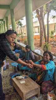 Saraswati tying me bracelet she made