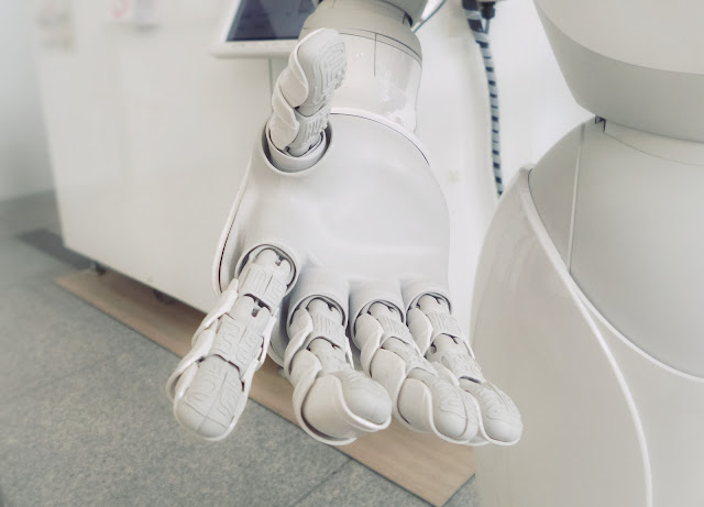 A robotic hand reaching out in a welcoming manner