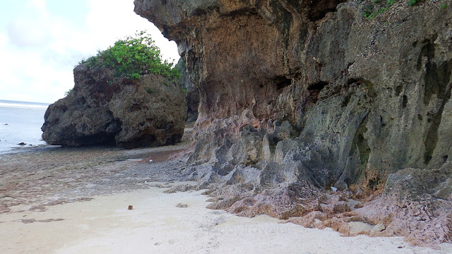 boulders and limestone cliffs at the southern end of the white sands of Jagnaya Yolanda Beach in Salcedo Eastern Samar