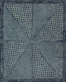 Nigerian adire textile with rotated triangle motif and other symbols.