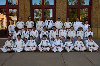 A group of taekwondo red belts posing for a group picture at martial arts comvention