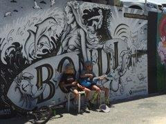 Young entrepreneurs trying to make some money in front of Bondi beach graffiti wall