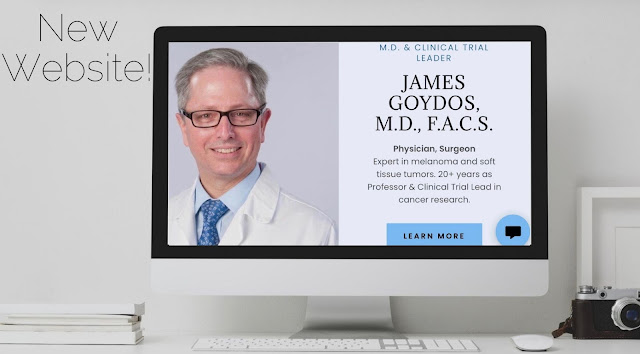 James Goydos MD - Professor, surgeon, clinical trial leader. 2020 new website announcement on computer screen. Computer on table next to a camera.