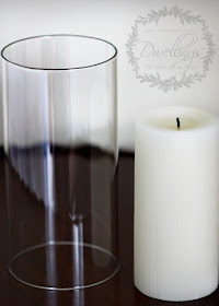 Glass sleeve and fluted vanilla candle in the guest room.