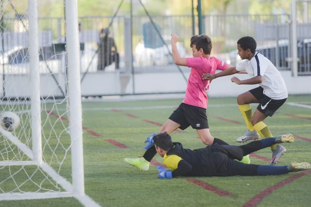 Unsplash free to use stock image of a child scoring a goal