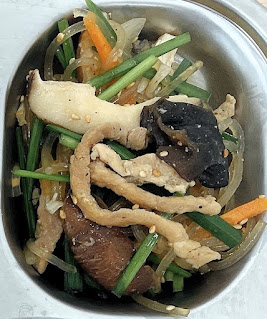 Stir-fried sweet potato starch noodles with pork, mushrooms, and vegetables