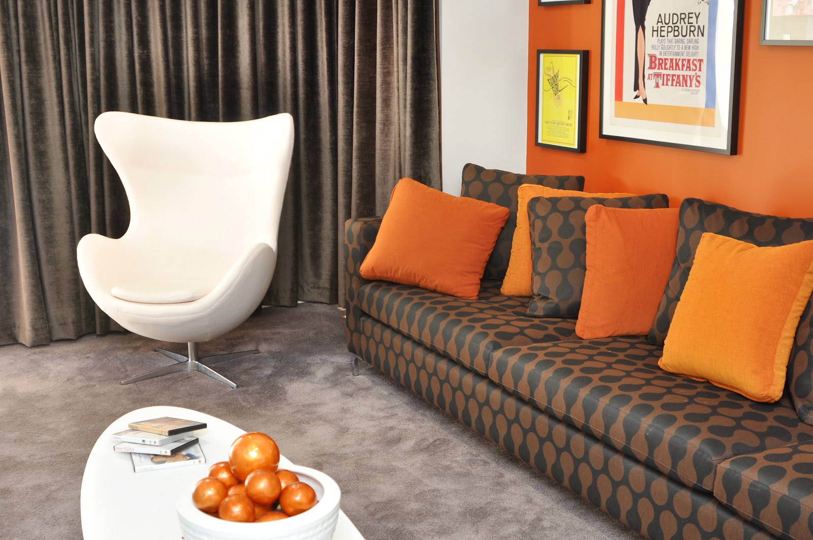 burnt orange feature wall ties in with the retro theme of this media ...