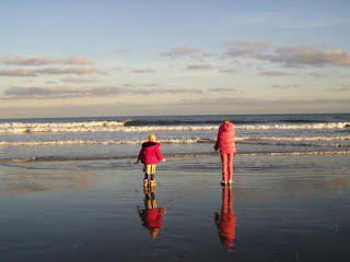 Two of our girls looking out over the ocean on a wintery day