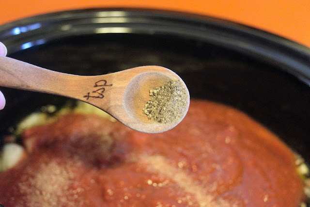 Pepper being added to the crockpot. 