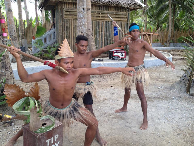 Ati tribe warriors post for tourists