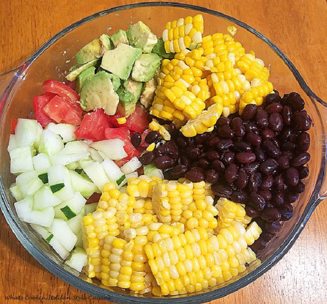 a medley of beans, corn, tomatoes and avocado salad