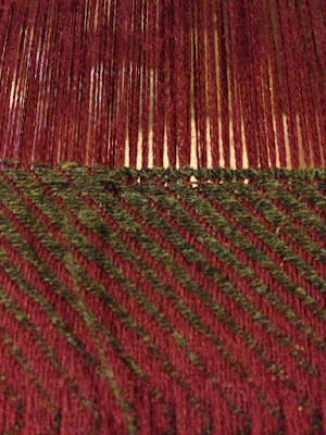 A close-up of brown hemstitching on a maroon and brown diagonal twill piece.