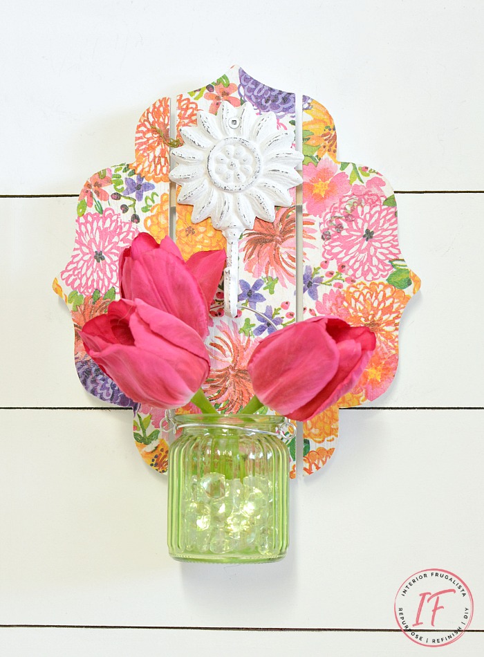 This DIY Decoupage Wall Sconce is an easy dollar store craft for Spring or Summer and can be used as a mason jar candle holder lantern or hanging flower vase.