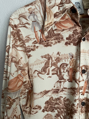 Up close image of a Kennington shirt with horses and gentlemen