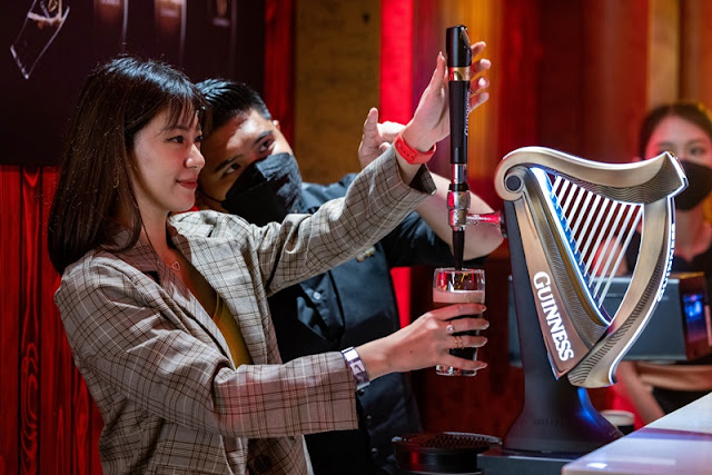 A guest attempting the two-part pour with expert guidance at Arthur_s Storehouse at Pavilion KL