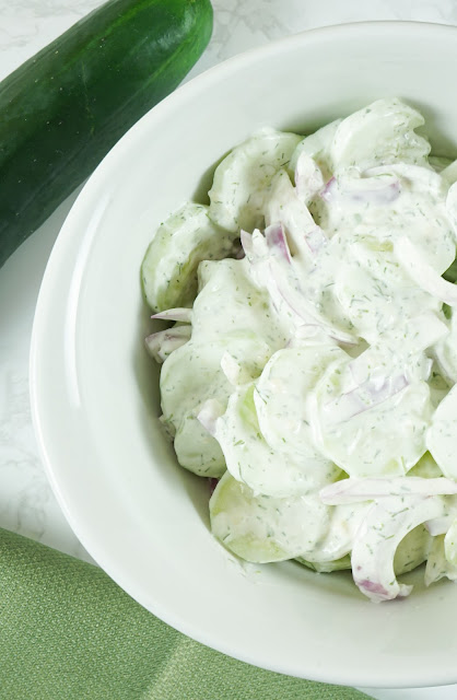 salad in a white bowl with green and white background.