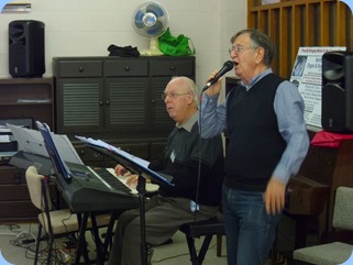 Peter Brophy and Len Hancy entertaining the members with a sing-along session.
