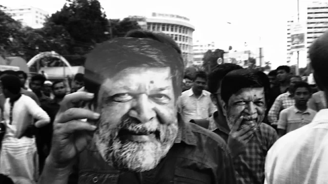 People gathered at the Shahbag Square in the Bangladesh capital of Dhaka wearing masks to protest the detention of internationally acclaimed photographer Shahidul Alam and other students. Image by Pranabesh Das, used with permission.