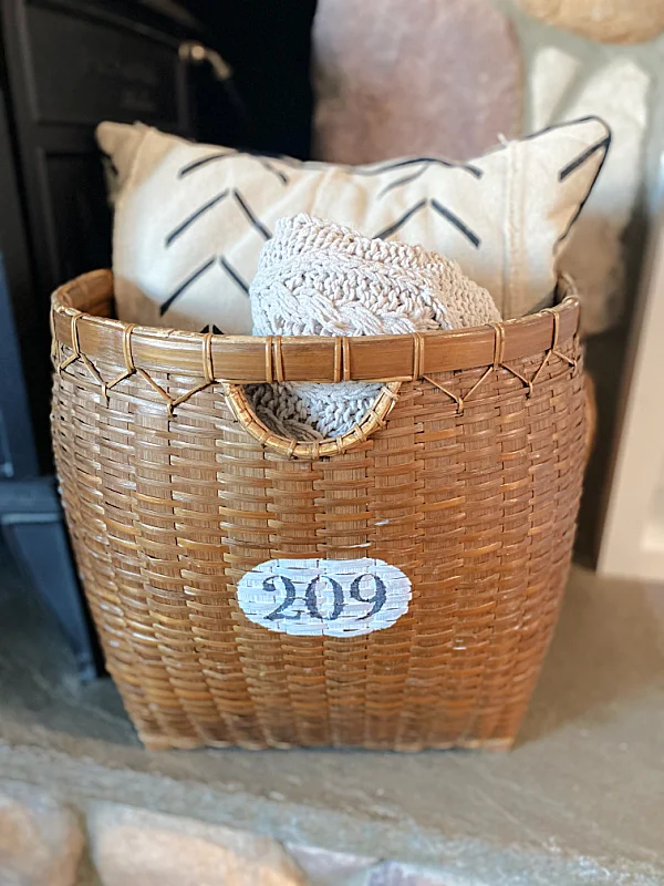 stenciled basket with blanket and pillow