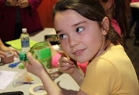 GSNC Invention Convention - Girl Scout Brownie Listening to the Musical Instrument She Created