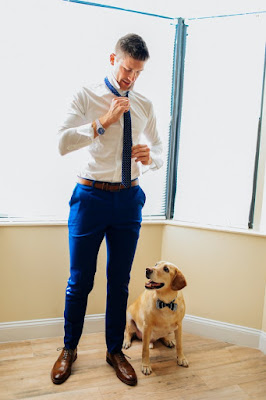 groom getting ready with pet before wedding