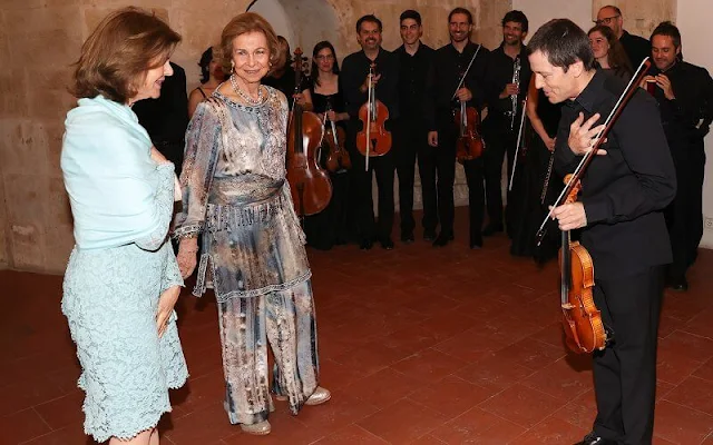 Queen Sofia and Queen Silvia attended a concert in Salamanca. Silvia wore a lace dress, Sofia wore a floral print silk jumpsuit