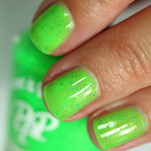 neon green nail polish with tiny blue glitters and sparkle