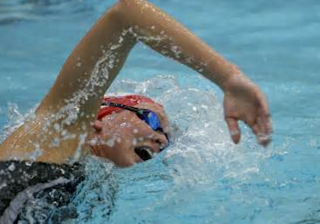 Image of a female swimmer in her breathing phase of freestyle: Swim Exercise Routine Can Be Monotonous