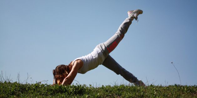 a women exercising in the grass