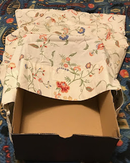 Found an old pillow case. Slip box into pillow case.