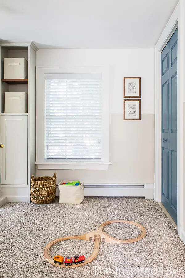 Boy's bedroom with vintage train art and blue doors.