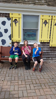 kids eating ice cream in front of ice cream parlor