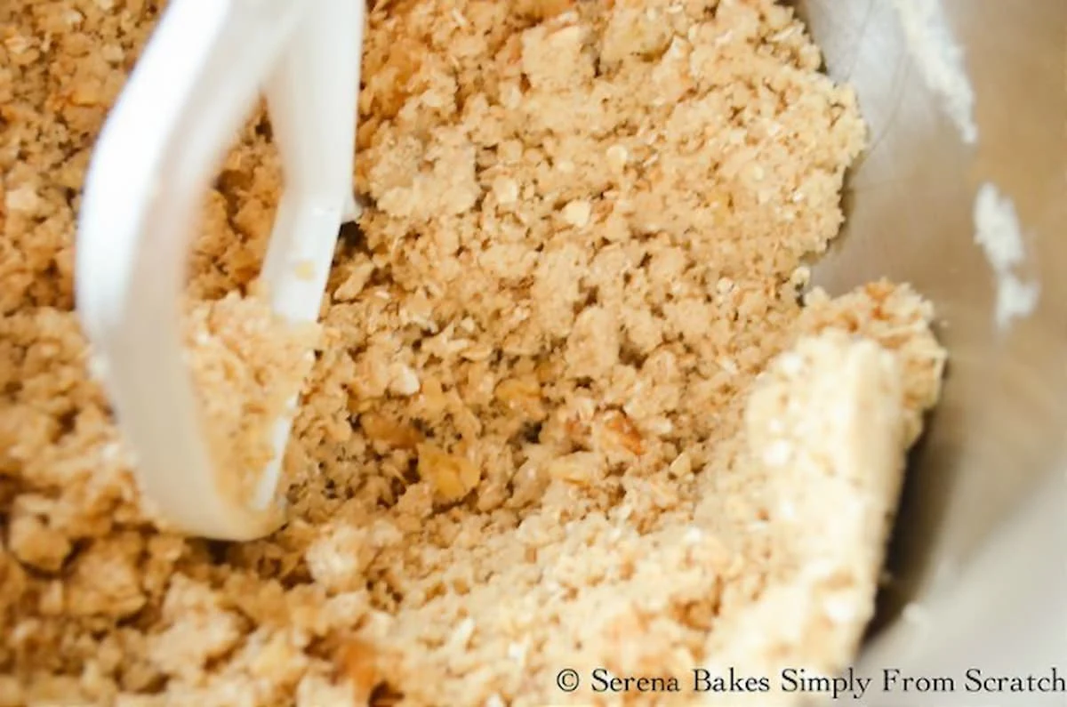 Best Apple Crisp topping in a stainless steel mixing bowl with a white paddle attachment.