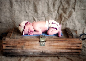 crocheted baseball outfit and old tool box with burlap backdrop