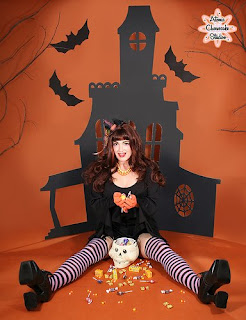 Pin-up image of a naughty trick-or-treater that has spilled all of her candy