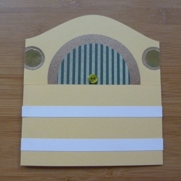 Laying white strips of paper across the greeting card front