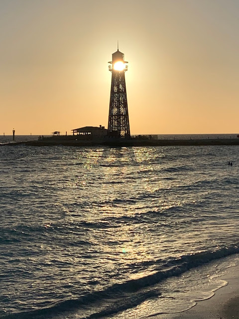 sun shining through lighthouse