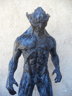 A humanoid monster stands in a menacing pose.