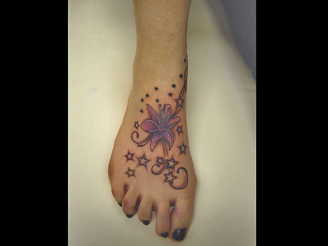 flower and star tattoos on foot. Foot & Ankle Tattoos: Floral & Stars. Something we get asked for a lot here 