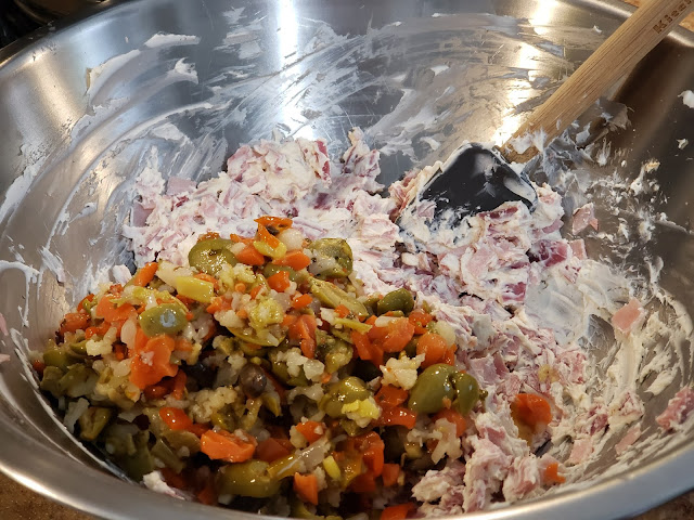 Stainless steel dish with olive salad and cheeses